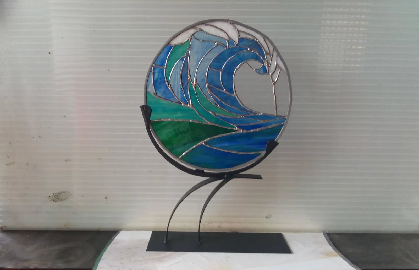 Stained glass with sculpted metal base
